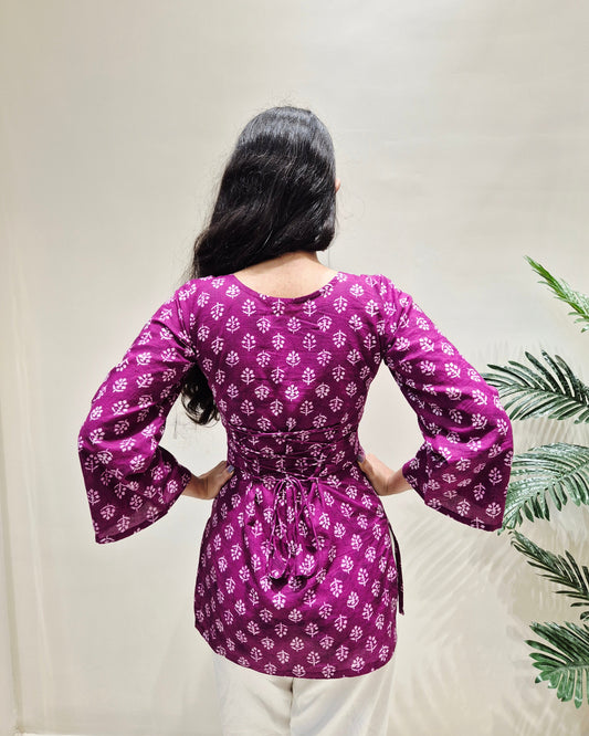 Person wearing a beautiful purple floral corset short kurti
