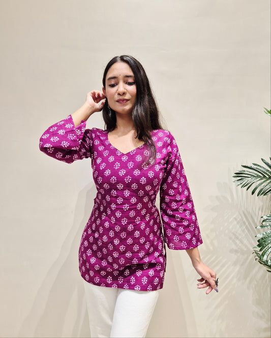 Woman wearing a purple patterned corset short kurti