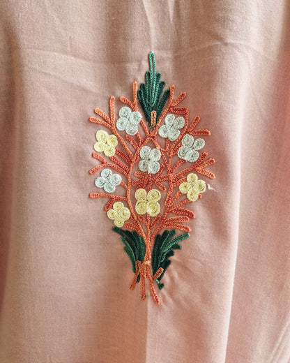 Embroidered floral design on a beige fabric background