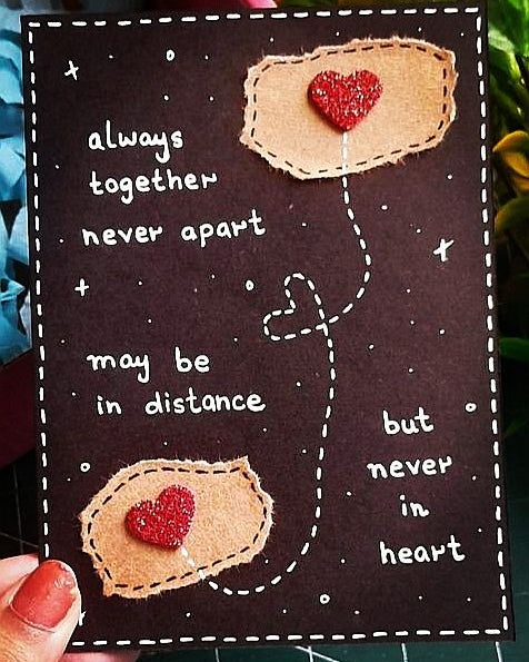 Card with heart shapes and text 'always together never apart' on a dark background